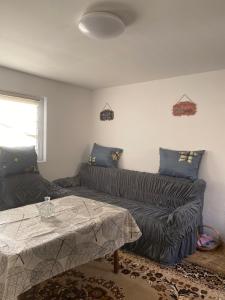 a living room with a couch and a table at Vikendica- kuća za odmor in Goražde