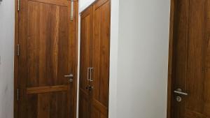 a pair of wooden doors in a room at nelli house in Galle