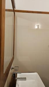 a bathroom with a white tub and a mirror at nelli house in Galle