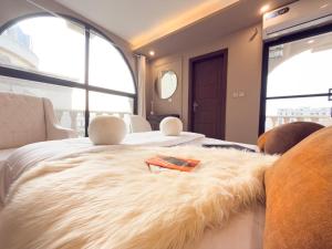 a bedroom with a bed with a fur blanket on it at The Marrakesh Suites - Skyline ApartHotel In Bahria Town in Rawalpindi