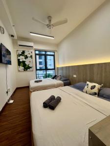 a bedroom with two beds and a ceiling at K avenue B3A 2bed studio room in Donggongon