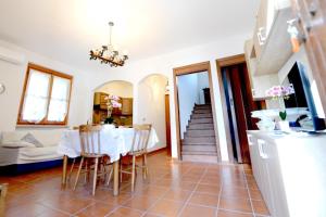 a dining room and living room with a table and chairs at B&B Resort Tina in Gesualdo