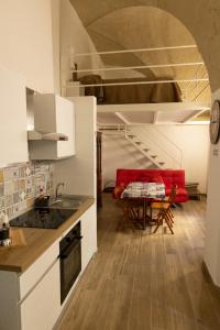 een keuken en een woonkamer met een rode bank bij Le Casarelle in Gaeta