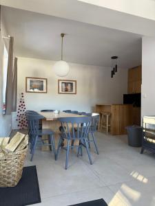 a dining room with blue chairs and a table at Vila Hraničná in Janov nad Nisou
