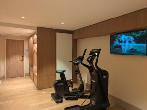 a gym with two exercise bikes in a room at Hôtel Le Cardinal in Paris