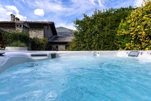 a hot tub in the backyard of a house at Le Parfum du Sel in Aosta