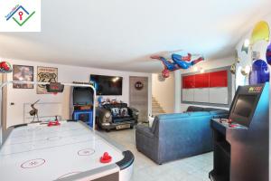 a living room with a ping pong table at Villa Irene in Castiglioncello by TuscanyWeGo in Chioma