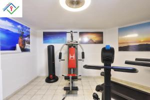 a room with a gym with exercise equipment at Villa Irene in Castiglioncello by TuscanyWeGo in Chioma