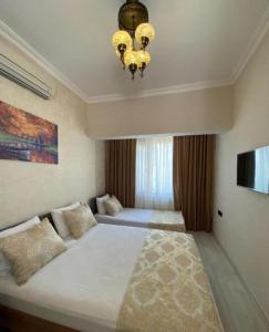 a bedroom with a large bed with a chandelier at My Home Premium in Sultanahmet