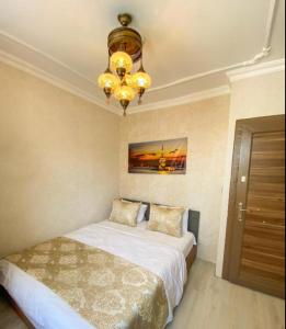 a bedroom with a bed and a chandelier at My Home Premium in Sultanahmet