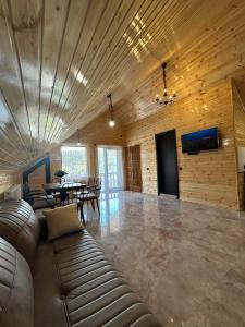 a living room with a leather couch and a table at Guest house marissi in Surami +43 photos