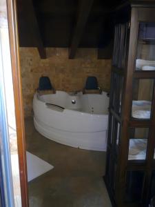 a white boat sitting in a room next to a shelf at Casona Asturiana Los Gamonales in Logrezana