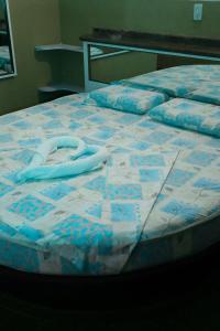 a bed with a blue and white quilt on it at New Auto Motel in Barcelona +16 photos