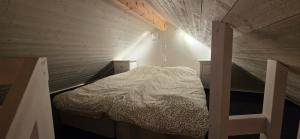 a small room with a bed in a attic at Aurora river cabin in Kiruna