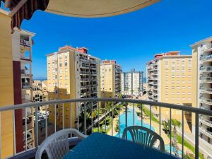a balcony with a table and chairs and buildings at Las Gondolas by Alina365 in La Manga del Mar Menor
