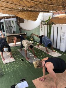 a group of people doing yoga on the floor at Pointbreak Surf Camp in Huanchaco +35 photos