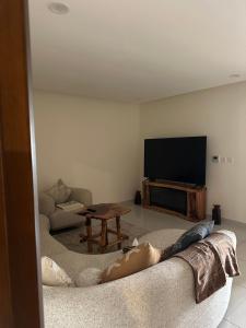 a woman laying on a couch in a living room at Sea and lake view apartment in Muscat +3 photos