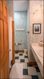 a bathroom with a shower and a sink and a toilet at Thurston House Inn in Ocracoke