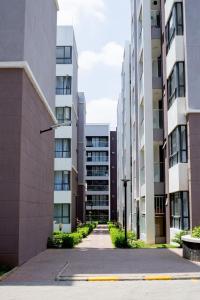 an empty street in a city with tall buildings at Studio near JKIA and SGR Syokimau in Nairobi