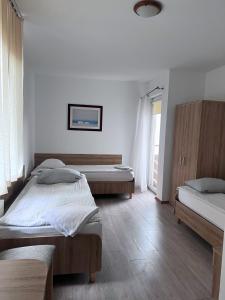 Postel nebo postele na pokoji v ubytování DW Belmara - Plaża Zachodnia - Ścieżka R10