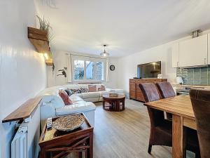 a living room with a couch and a table at 6 bedroom, 5 bathroom villa near Paris in Saint-Denis