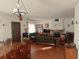 a living room with a table and a dining room at La Libélula de Valles in Puebla de Vallés