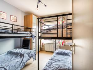 2 Etagenbetten in einem Zimmer mit einer Tür in der Unterkunft Argenteuil eerste in Galopen