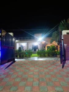 a night view of a house with a driveway at The Starlight Farmstay- Poolside Tent Stay in Jaipur in Jāmb