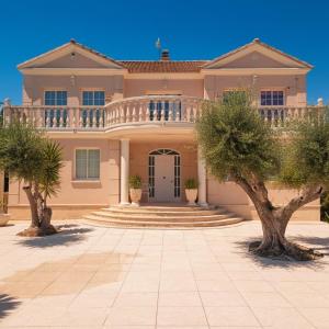 a large house with a balcony on top of it at Costa Dorada Villa - Pool BBQ Beach 5min in Calafell