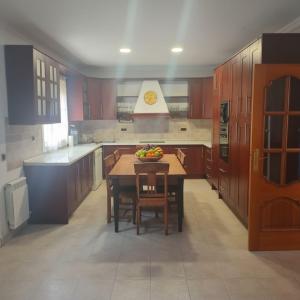 a kitchen with a table with a bowl of fruit on it at Costa Dorada Villa - Pool BBQ Beach 5min in Calafell