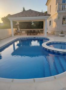 a swimming pool in a backyard with a gazebo at Costa Dorada Villa - Pool BBQ Beach 5min in Calafell