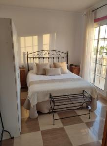 a bedroom with a large bed with pillows on it at Costa Dorada Villa - Pool BBQ Beach 5min in Calafell
