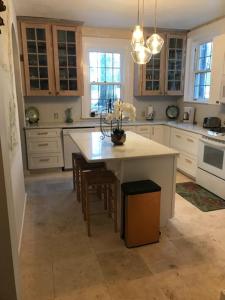 a kitchen with a island with a table and chairs at Mill Creek Mansion in Youngstown