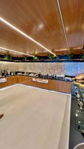 a dining room with a table and a counter at Hotel Costa do Atlantico in Natal +62 photos