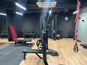 a gym with dumbbells and weights in a room at Riverside Industrial Studios - SAUNA - GYM -air-conditioning-SPA-FITNESS in Wrocław