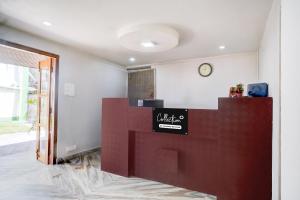 a lobby with a counter with a clock on the wall at Super Collection O Police Bazar Shillong Formerly Pillars House in Shillong