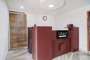 a lobby with a counter with a sign on it at Super Collection O Police Bazar Shillong Formerly Pillars House in Shillong