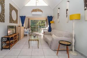 a living room with a couch and a tv at The Bridge, Apartment 67 in St Lucia