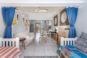 a living room with blue drapes and a kitchen at The Bridge, Apartment 67 in St Lucia