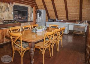 a dining room with a wooden table and chairs at Gunyatoo Trout Trout Farm & Guest Lodge in Sabie