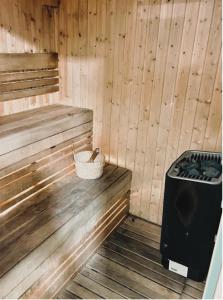 a sauna with a stove and a bucket in it at Yas Island Mayan 2 Junior 1 Bed Apartment by Central Stay in Abu Dhabi