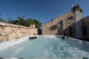a jacuzzi tub in a stone wall at Villa Vidonjica in Novalja