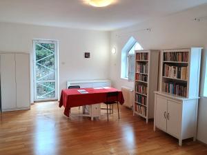 a dining room with a table and a book shelf at Ubytování nad kostelem in Prague