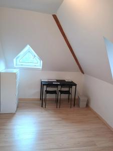 a dining room with a table and chairs in a attic at Ubytování nad kostelem in Prague