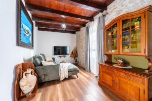 a living room with a couch and a cabinet at Villa Vidonjica in Novalja