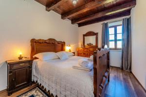 a bedroom with a bed with a dresser and a mirror at Villa Vidonjica in Novalja +37 photos