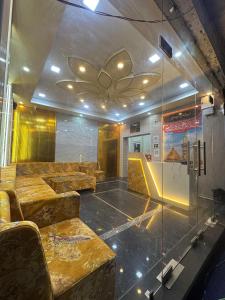 a waiting room with couches and a glass wall at Baghdad Palace Near Dargah sharif in Ajmer