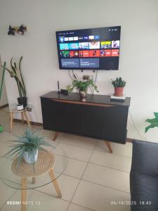 una sala de estar con un televisor de pantalla plana sobre un mueble en ACOGEDOR ÀPARTAMENTO A CUADRAS DE CAVANCHA, en Iquique