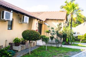 a house with trees in front of it at Stopover lodge in Rustenburg