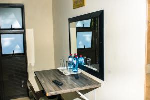 a table with bottles of water and a mirror at Stopover lodge in Rustenburg